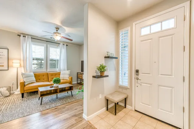 a living room with furniture and wooden floor