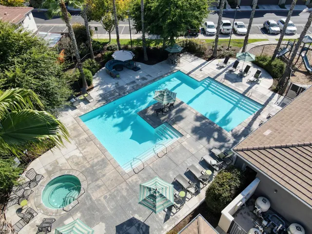 an aerial view of residential houses with outdoor space