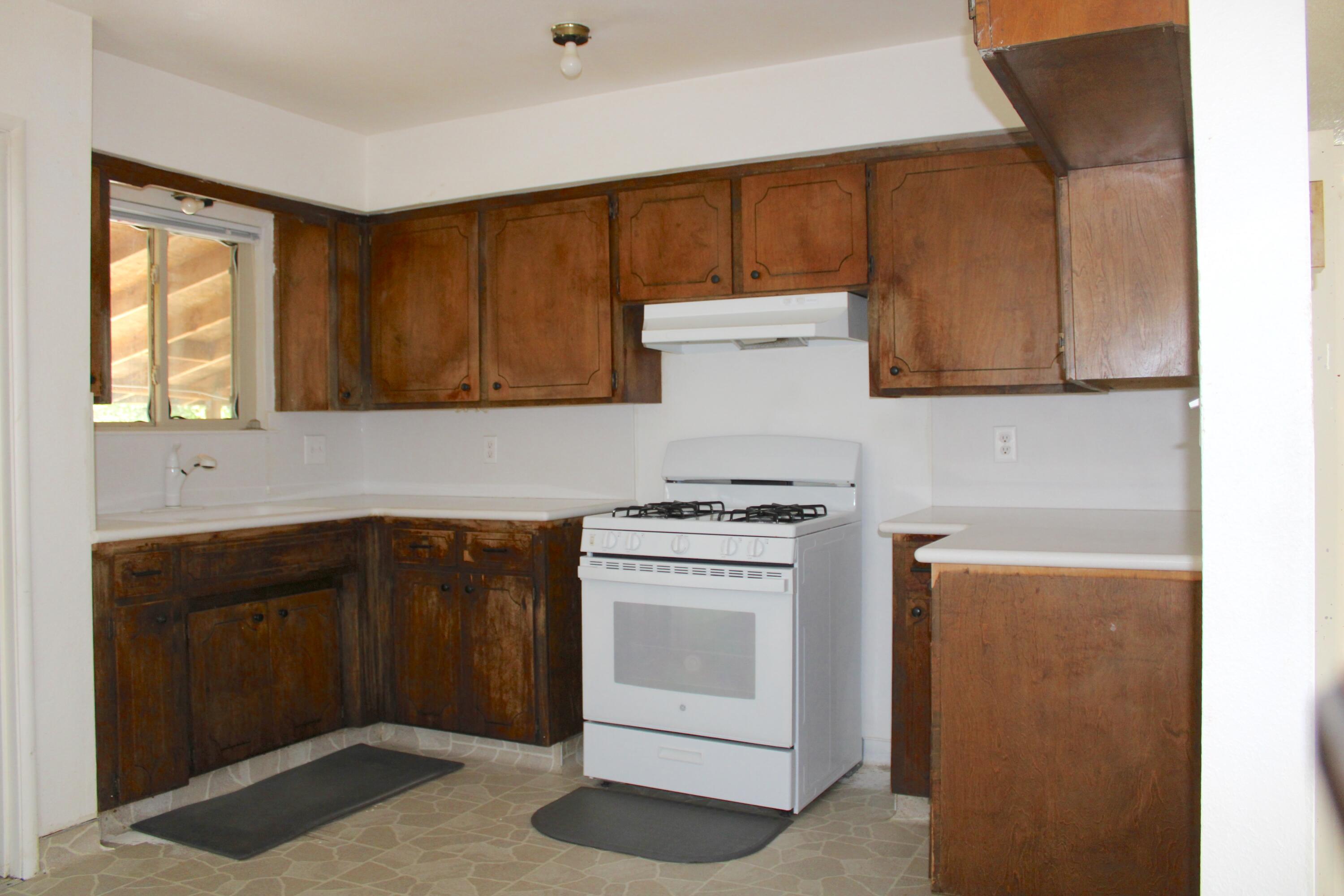 517 South R Street Tulare, CA 93274 - Photo 3 of 21 a kitchen with a stove and cabinets