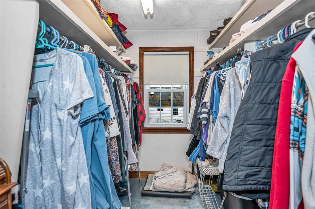 9 Allen Road Waltham, MA 02453 - Photo 22 of 40 a view of walk in closet with clothes and shoes