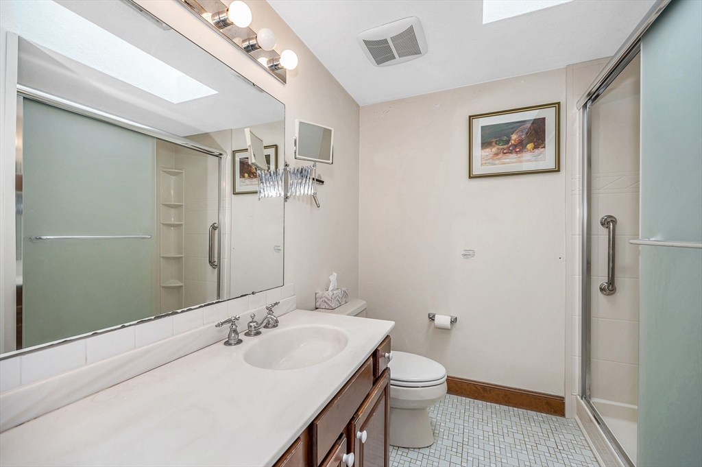 9 Allen Road Waltham, MA 02453 - Photo 23 of 40 a bathroom with a sink a toilet and shower