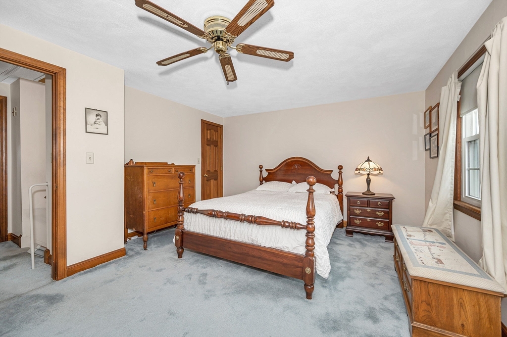 9 Allen Road Waltham, MA 02453 - Photo 24 of 40 a spacious bedroom with a bed a dresser and a chandelier