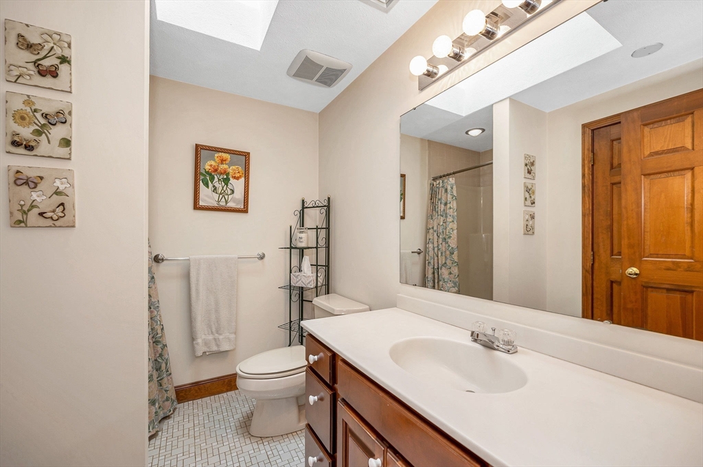 9 Allen Road Waltham, MA 02453 - Photo 26 of 40 a bathroom with a toilet a sink and mirror