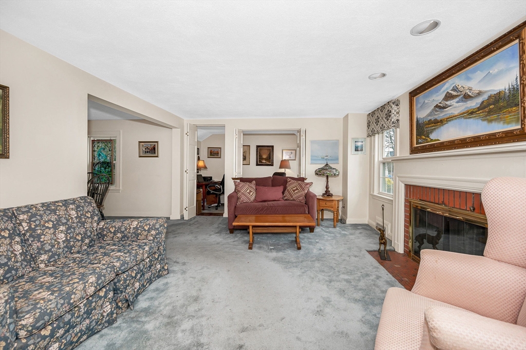 9 Allen Road Waltham, MA 02453 - Photo 3 of 40 a living room with furniture and a fireplace