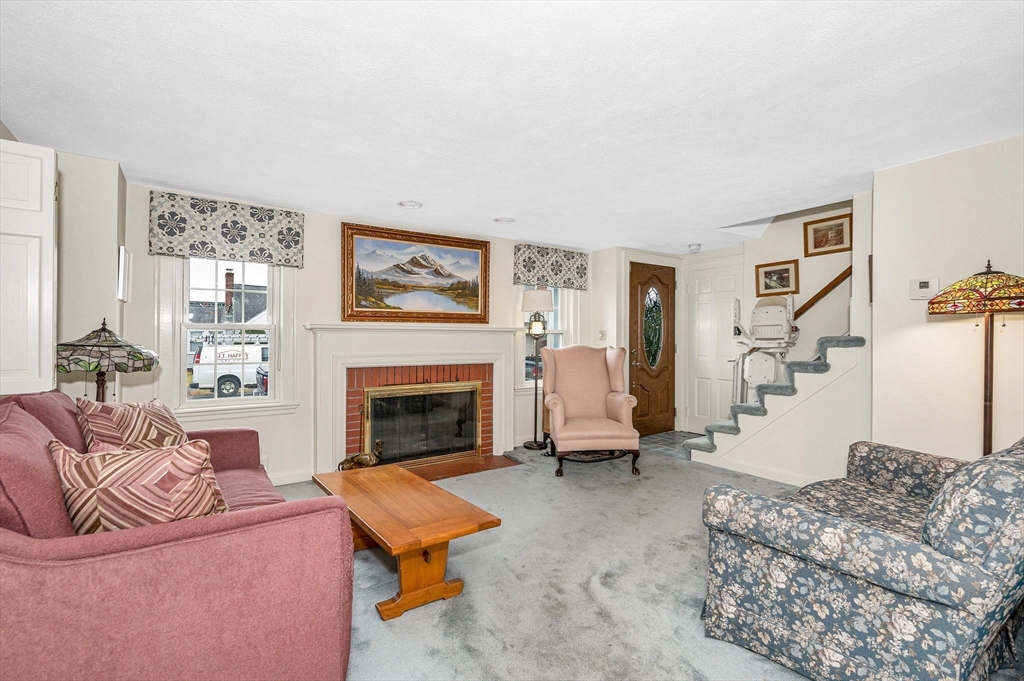 9 Allen Road Waltham, MA 02453 - Photo 5 of 40 a living room with furniture and a fireplace