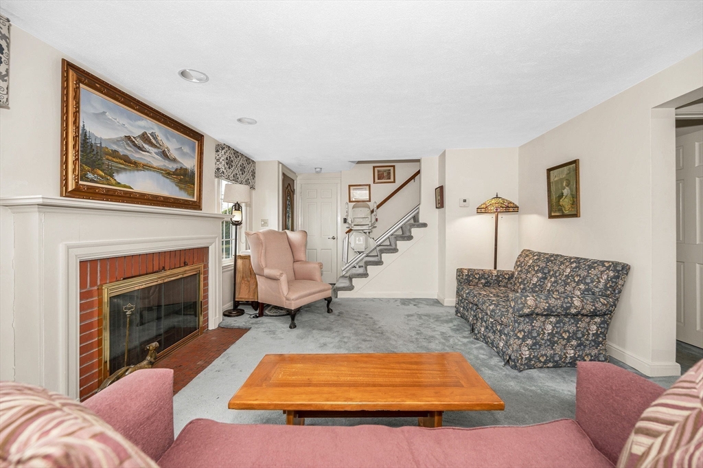9 Allen Road Waltham, MA 02453 - Photo 6 of 40 a living room with furniture and a fireplace