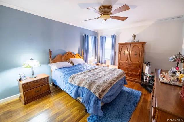 a bedroom with bed and wooden floor
