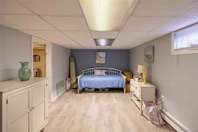 a spacious bedroom with a bed and a dresser in it