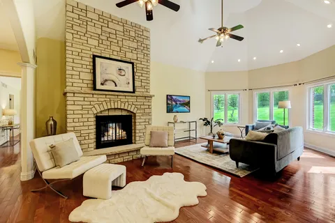a living room with furniture fireplace and window