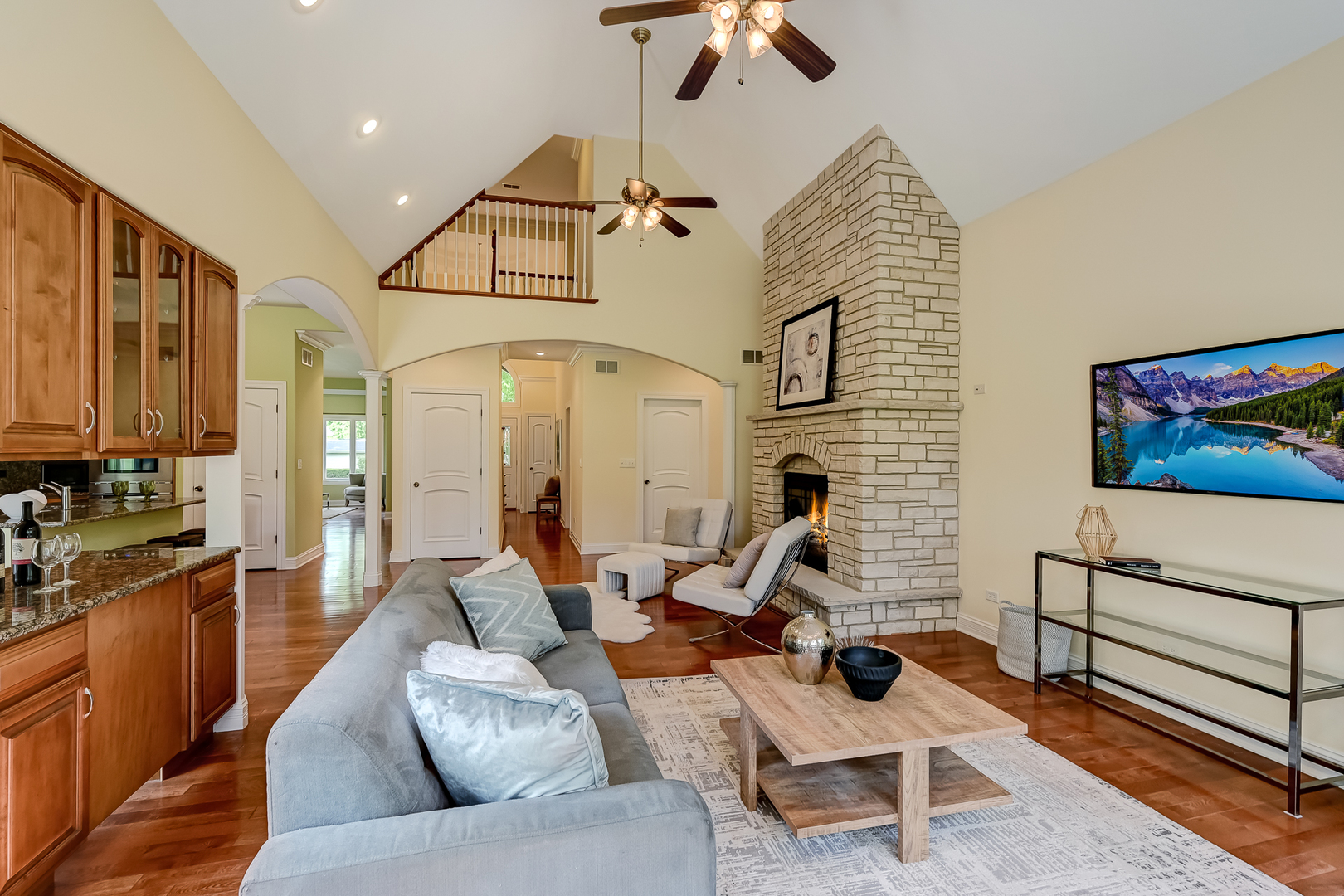 8827 Palisades Road Burr Ridge, IL 60527 - Photo 15 of 35 a living room with furniture a flat screen tv and kitchen view