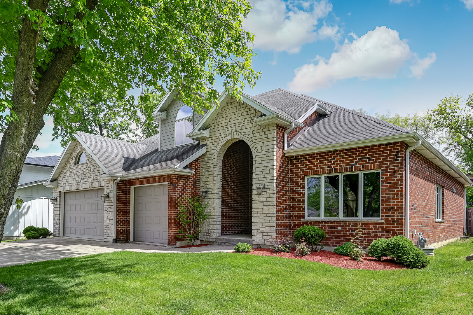 8827 Palisades Road Burr Ridge, IL 60527 - Photo 2 of 35 a front view of a house with a yard and garage