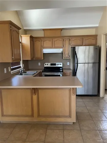 a kitchen with a refrigerator and a sink
