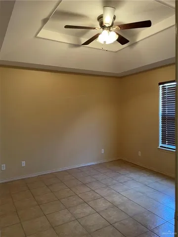 an empty room with a empty space and a ceiling fan