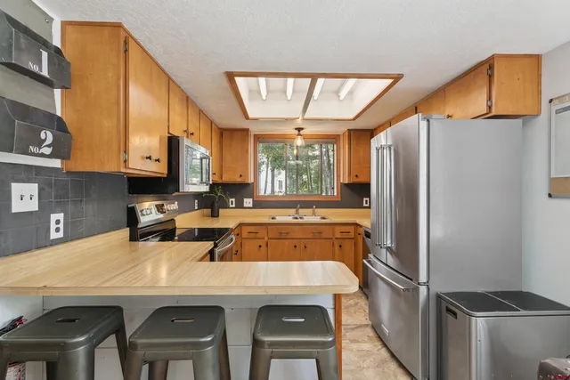 a kitchen with refrigerator and window