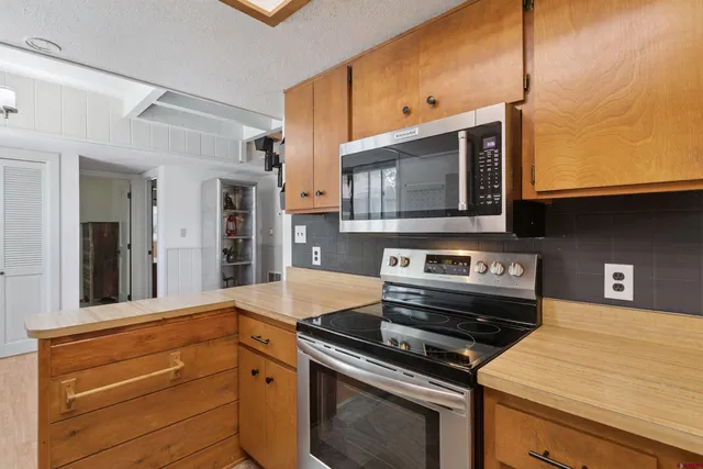 a kitchen with a stove and a microwave
