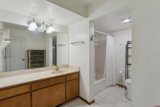 a bathroom with a double vanity sink mirror and shower