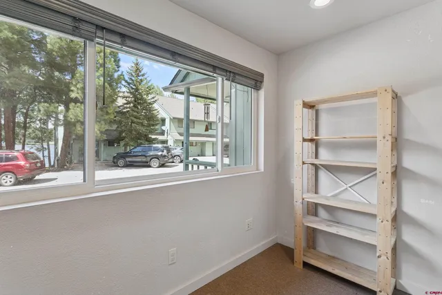 a view of a room with wooden floor and windows