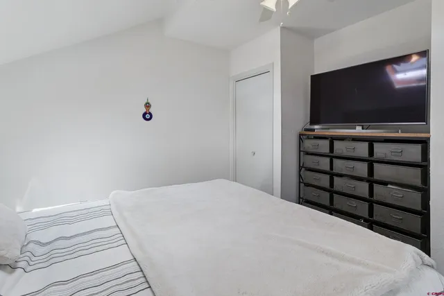 a bedroom with a bed and a flat screen tv