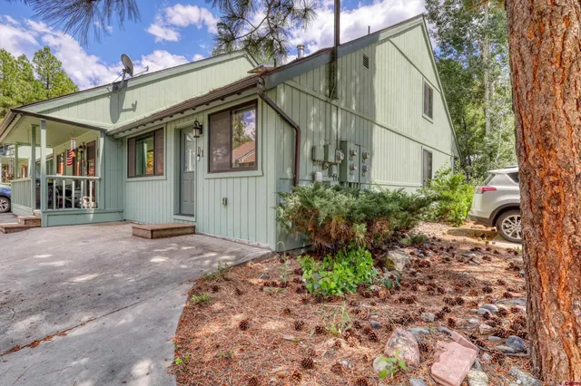a yellow house with trees in front of it