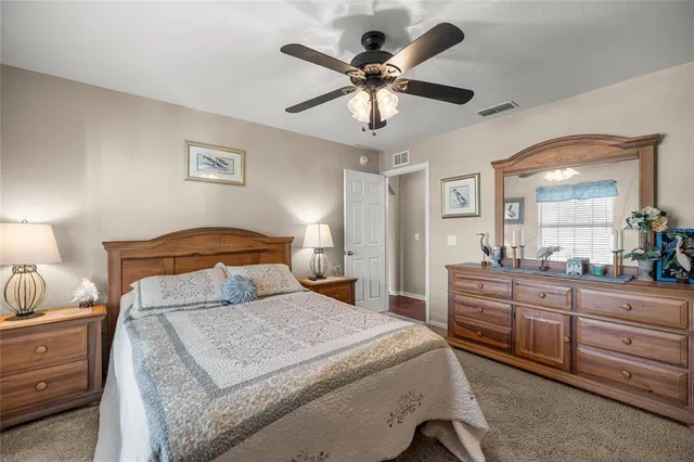 a bedroom with a large bed and a chandelier