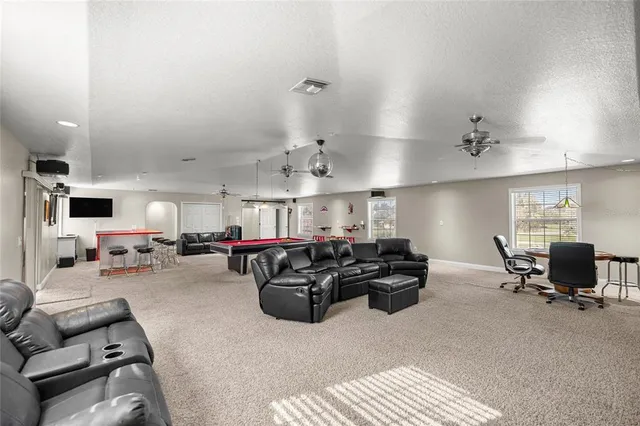 a living room with furniture and kitchen view