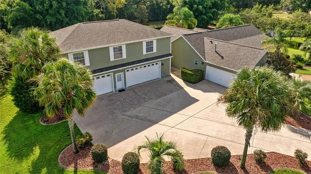 an aerial view of a house with a yard and potted plants
