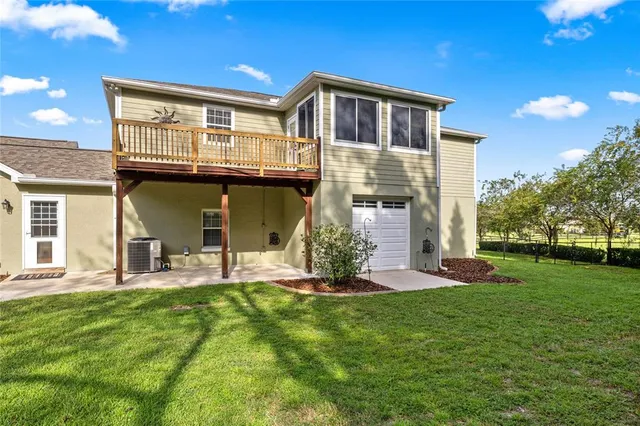 an aerial view of a house with garden space ocean view