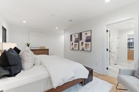 a spacious bathroom with a granite countertop sink mirror and a shower