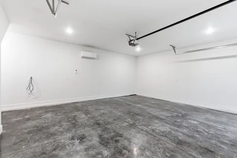 an empty room with wooden floor closet and fan