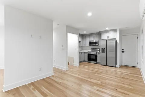 a view of a kitchen with microwave and refrigerator