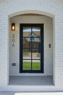 a living room with furniture a rug and a window