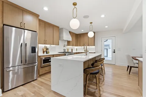 a kitchen with cabinets a sink and appliances