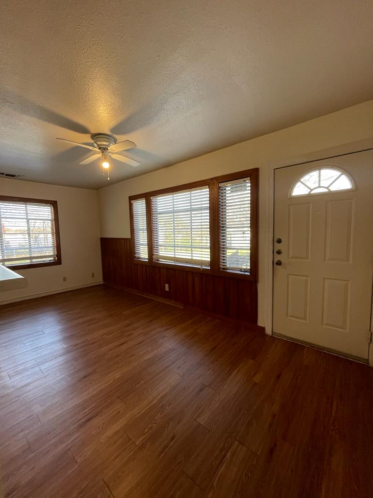 108 Austin Street, Unit B Kyle, TX 78640 - Photo 2 of 14 A welcoming entry area with rich wood flooring and abundant natural light invites comfortable living.