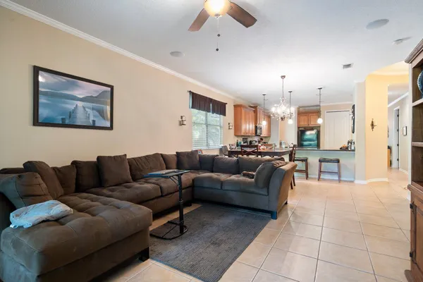 a living room with furniture and a chandelier