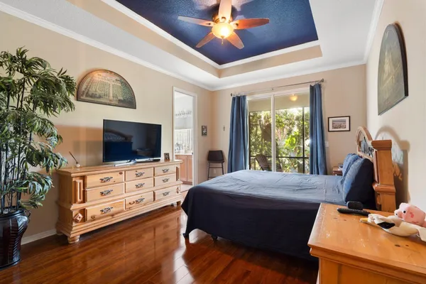 a bedroom with furniture flat screen tv and a fireplace