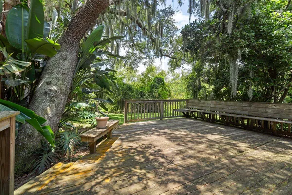 a view of a yard with wooden fence