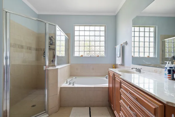 a bathroom with a tub sink and mirror