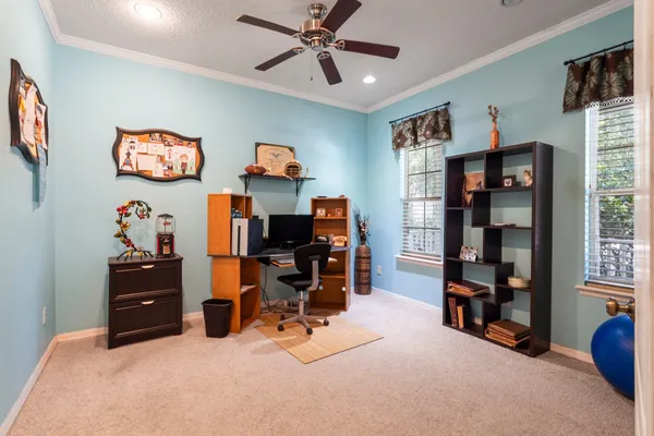 a view of a workspace with furniture and a window