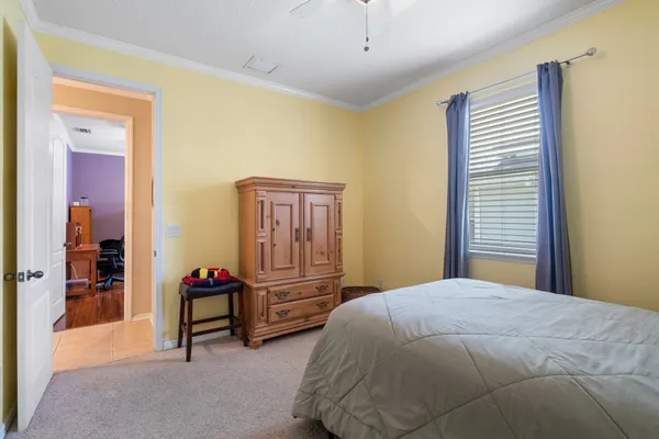 a bedroom with two beds and a desk