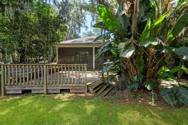 a view of a house with a yard and a deck