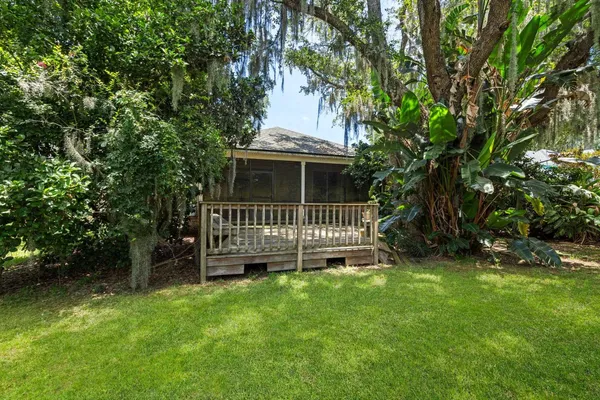 a view of green field with trees in the background