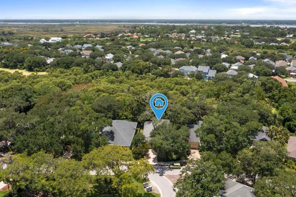 an aerial view of a house with a yard