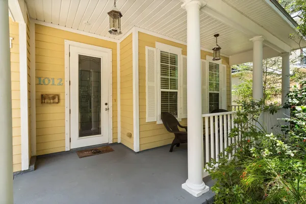 a view of a balcony with chair and door