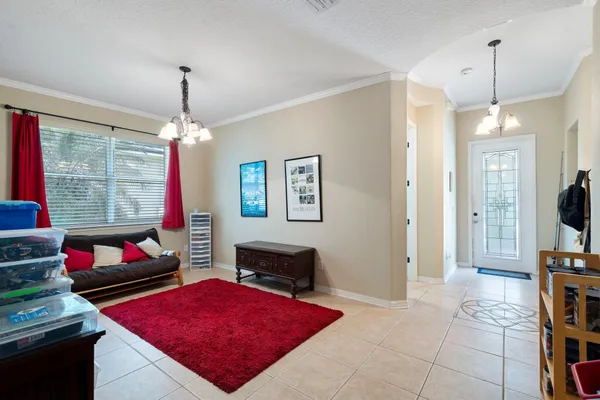 a living room with furniture a window and a flat screen tv
