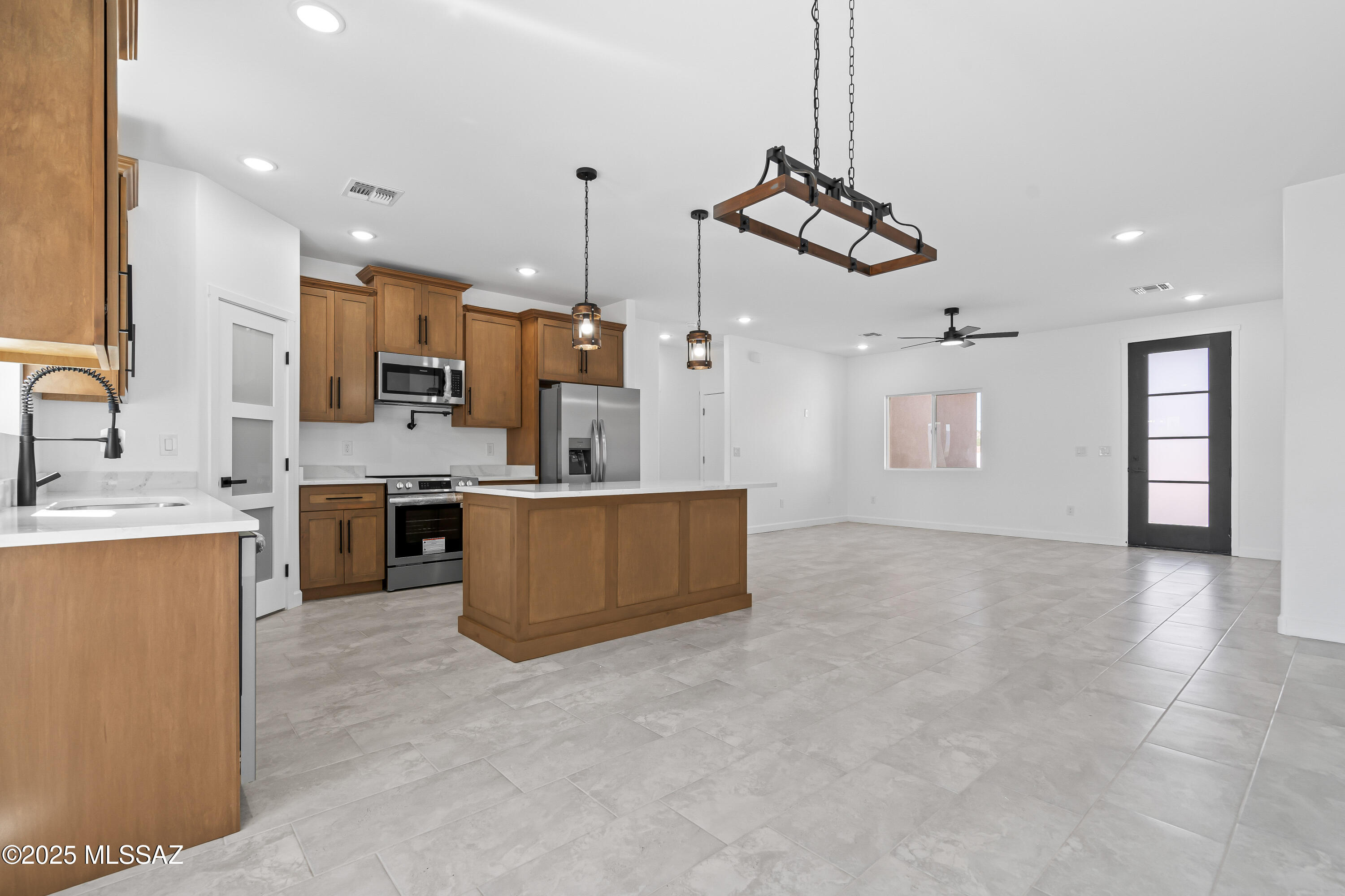 1667 Ave Calamar Rio Rico, AZ 85648 - Photo 16 of 33 a view of kitchen with stainless steel appliances kitchen island a large counter top and a view of living room