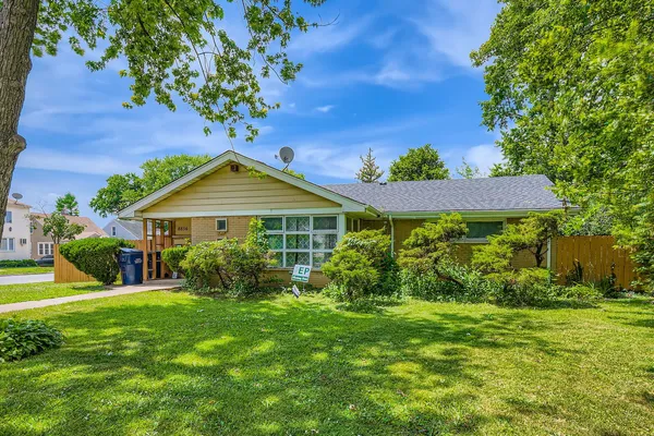 a front view of house with yard and green space