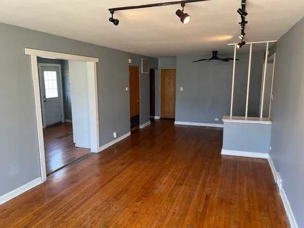 a view of hallway with wooden floor