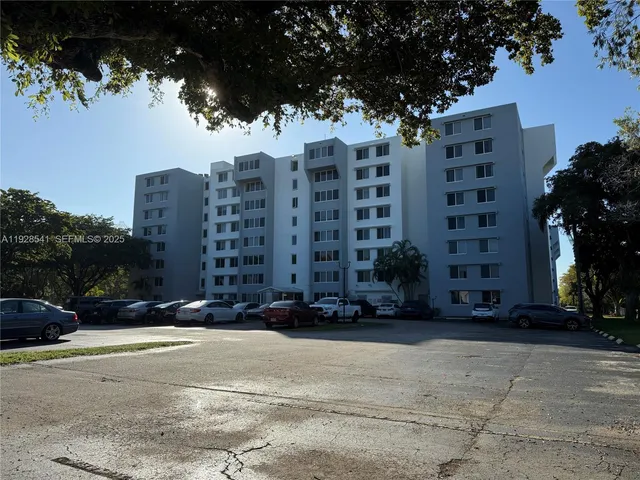 a tall building with trees in front of it