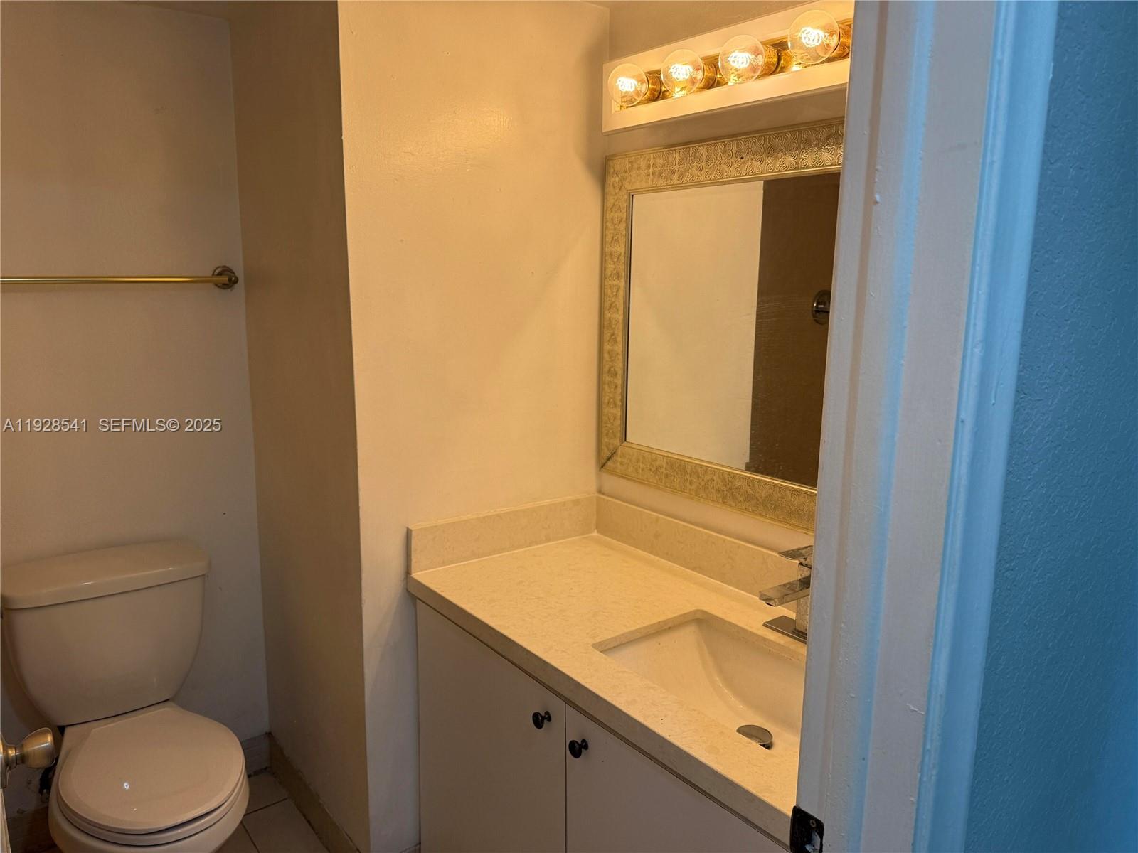 9001 Southwest 77th Avenue, Unit C709 Miami, FL 33156 - Photo 11 of 17 a bathroom with a granite countertop sink toilet and shower