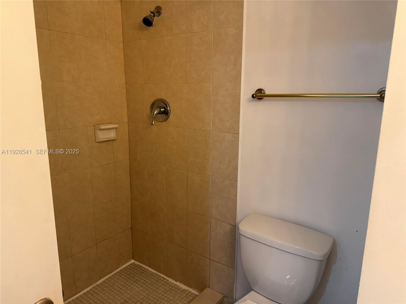 9001 Southwest 77th Avenue, Unit C709 Miami, FL 33156 - Photo 12 of 17 a bathroom with a toilet and a shower